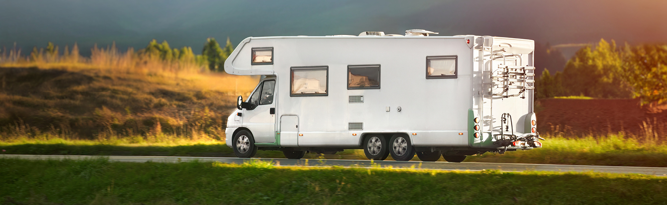 An RV camper parked in a nature setting.