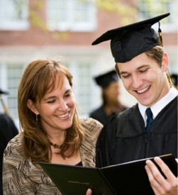 A college student wearing a graduation cap and his mother are happily looking at his diploma. 