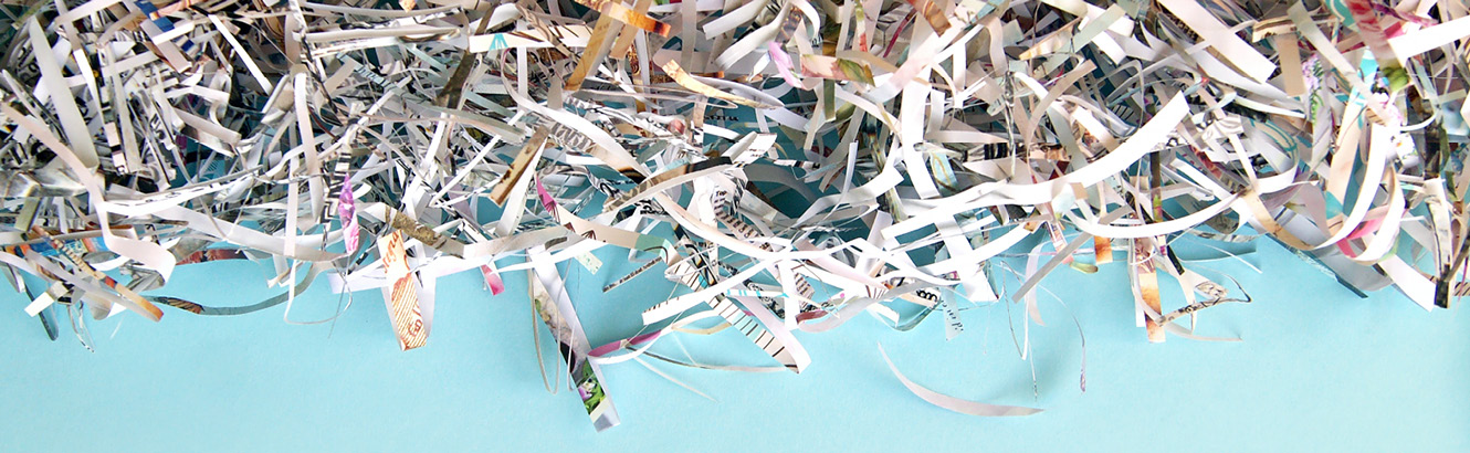 Shredded paper on a light blue background.